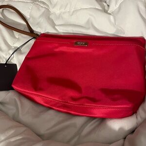 Brand new Tumi clutch